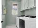 Functional laundry room featuring modern, front-load washer and dryer, ample cabinet space, and bright natural light at 3769 Summerton St, Mount Pleasant, SC 29466