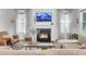 Cozy living room features a fireplace, large windows with curtains, and comfortable seating arrangements at 3769 Summerton St, Mount Pleasant, SC 29466