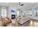 Bright living room features a fireplace, ceiling fan, hardwood floors, and multiple windows for natural light at 3769 Summerton St, Mount Pleasant, SC 29466