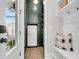 Mud room features built in cabinet storage with a vintage refrigerator, bench seating and outdoor views at 3769 Summerton St, Mount Pleasant, SC 29466