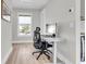 Bright home office features a standing desk, ergonomic chair, and a sunlit window offering neighborhood views at 3769 Summerton St, Mount Pleasant, SC 29466
