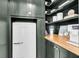 Butler's pantry featuring dark green cabinets, butcher block countertops and a retro mini fridge at 3769 Summerton St, Mount Pleasant, SC 29466