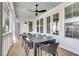 Inviting screened porch with ceiling fan, dining table, and chairs for enjoyable outdoor entertaining at 3769 Summerton St, Mount Pleasant, SC 29466