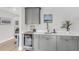 Modern wet bar boasts sleek gray cabinetry, ample counter space, a stylish beverage cooler, and task lighting at 3769 Summerton St, Mount Pleasant, SC 29466