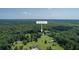 Aerial view of 395 Sommerset Lane, featuring a round home and surrounded by lush greenery and mature trees at 395 Summerset Ln, Summerville, SC 29483
