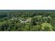 Aerial view of a unique round home nestled in a neighborhood with lush greenery and mature trees at 395 Summerset Ln, Summerville, SC 29483