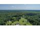 Aerial view showcasing a round home on a sprawling lot, blending nature with unique architecture at 395 Summerset Ln, Summerville, SC 29483