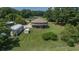 Aerial view showing a unique round home, multiple outbuildings, and a long driveway within a wooded area at 395 Summerset Ln, Summerville, SC 29483