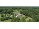 Aerial shot highlighting the unique round house and the lush, green landscapes surrounding it at 395 Summerset Ln, Summerville, SC 29483