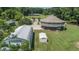 Areal view of a unique round home, along with multiple outbuildings and a long driveway at 395 Summerset Ln, Summerville, SC 29483