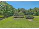 Expansive backyard featuring a lush lawn, mature trees, and ample space for outdoor activities at 395 Summerset Ln, Summerville, SC 29483
