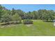 A sprawling backyard showcases a verdant lawn, bordered by dense trees, and an open fence at 395 Summerset Ln, Summerville, SC 29483