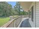 Wooden balcony with views of the yard and surrounding nature, offering serene outdoor living at 395 Summerset Ln, Summerville, SC 29483
