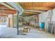 Unfinished basement showcasing storage shelves and plumbing under exposed wooden beams at 395 Summerset Ln, Summerville, SC 29483