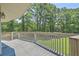 Open-air wooden deck with white railings overlooking a grassy lawn and a lush green treeline at 395 Summerset Ln, Summerville, SC 29483