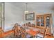 Charming dining room features hardwood floors, elegant furnishings, and ample natural light at 395 Summerset Ln, Summerville, SC 29483