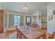 Traditional dining room with wood table, hardwood floors, and natural light from the large window at 395 Summerset Ln, Summerville, SC 29483