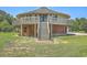 Unique round house featuring a brick base and a wooden balcony surrounding the second story at 395 Summerset Ln, Summerville, SC 29483