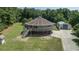 Unique round house with a second-story deck, plus a storage building, all surrounded by green lawns at 395 Summerset Ln, Summerville, SC 29483