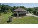Unique round house with a second-story deck, surrounded by lush greenery and a large yard at 395 Summerset Ln, Summerville, SC 29483