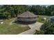 Aerial view of a round house with a wraparound deck, complemented by well-maintained grounds at 395 Summerset Ln, Summerville, SC 29483
