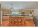 An eat-in kitchen featuring a large island with seating, custom cabinets, granite countertops, and stainless steel appliances at 395 Summerset Ln, Summerville, SC 29483
