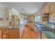 Well-appointed kitchen with a large island, custom cabinets, granite counters, stainless appliances, and hardwood floors at 395 Summerset Ln, Summerville, SC 29483