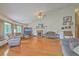 Open-concept living room with vaulted ceiling, hardwood floors, fireplace, and an abundance of natural light from multiple windows at 395 Summerset Ln, Summerville, SC 29483