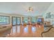 A spacious living room features hardwood floors, neutral walls, a fireplace, and multiple windows offering plenty of natural light at 395 Summerset Ln, Summerville, SC 29483