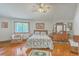 Comfortable main bedroom with hardwood floors, large window, and traditional decor at 395 Summerset Ln, Summerville, SC 29483