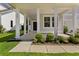 Inviting covered front porch with white columns, manicured bushes and well maintained walkway at 425 W Respite Ln, Summerville, SC 29483