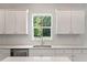 Kitchen with stainless steel appliances, white subway tile backsplash, and a window with view of lush trees at 425 W Respite Ln, Summerville, SC 29483