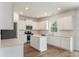 Bright kitchen features an island, stainless steel appliances, white cabinets, and hardwood floors at 425 W Respite Ln, Summerville, SC 29483
