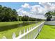 Backyard pond view with white picket fence in the foreground at 425 W Respite Ln, Summerville, SC 29483