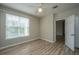 Empty bedroom with wood floors, ceiling fan, window, and closet at 45 Scyamore Ave # 623, Charleston, SC 29407