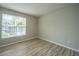 Bright bedroom featuring a window with wooded views and attractive wood-look flooring at 45 Scyamore Ave # 623, Charleston, SC 29407