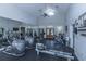 Bright gym with workout equipment, high ceilings, ceiling fans, and mirrors, and view through doorway at 45 Scyamore Ave # 623, Charleston, SC 29407