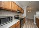 Well-equipped kitchen with stainless steel appliances, wooden cabinets, and an adjacent dining area at 45 Scyamore Ave # 623, Charleston, SC 29407