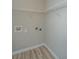 Empty laundry room with wood floors and utility connections at 45 Scyamore Ave # 623, Charleston, SC 29407