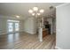 Bright living room with wood floors, double doors to balcony, and chandelier at 45 Scyamore Ave # 623, Charleston, SC 29407