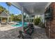 Covered patio overlooking a community pool with comfortable seating at 45 Scyamore Ave # 623, Charleston, SC 29407