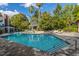 Relaxing community pool with a gazebo, lounge chairs, and mature trees at 45 Scyamore Ave # 623, Charleston, SC 29407