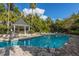 A refreshing swimming pool with a gazebo and lounge chairs, surrounded by palm trees at 45 Scyamore Ave # 623, Charleston, SC 29407