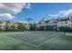 Well-maintained tennis court surrounded by lush landscaping and with multiple townhomes in background at 45 Scyamore Ave # 623, Charleston, SC 29407