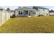 Spacious backyard with lush lawn and a charming home featuring a screened porch at 5000 Paddy Field Way, Ladson, SC 29456