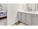 Bathroom with double sinks, white cabinets, and a view into an adjacent bedroom at 5000 Paddy Field Way, Ladson, SC 29456