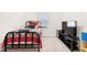 Simple bedroom with a patterned bedspread, window, and an entertainment center at 5000 Paddy Field Way, Ladson, SC 29456