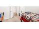 Cozy bedroom with a patterned bedspread, window, and a shelf at 5000 Paddy Field Way, Ladson, SC 29456