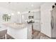 Bright, modern kitchen features an island with pendant lighting and stainless steel appliances at 5000 Paddy Field Way, Ladson, SC 29456