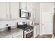 Modern kitchen featuring stainless steel appliances, gray cabinets, and granite countertops at 5000 Paddy Field Way, Ladson, SC 29456